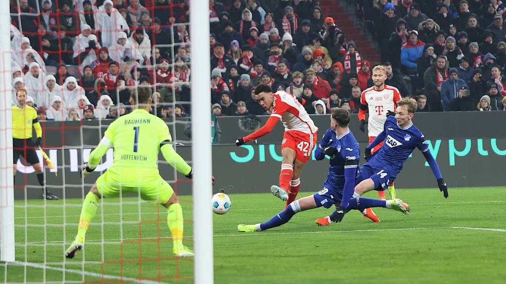 Jamal Musiala taking a shot on goal in FC Bayern's Bundesliga game against TSG Hoffenheim