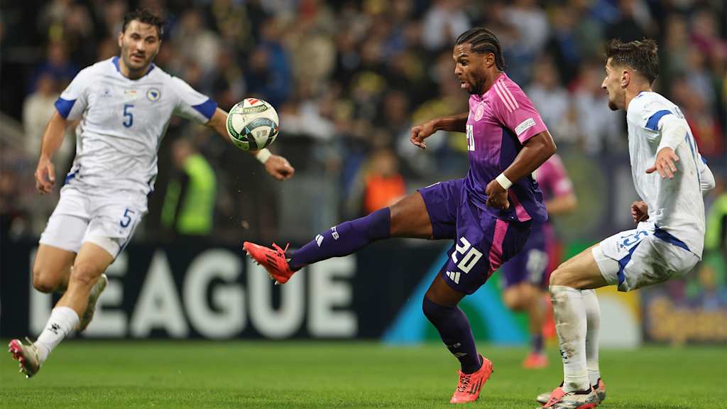 Serge Gnabry controls the ball under pressure from Bosnia's Armin Gigovic