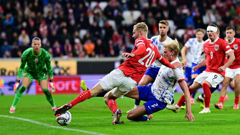 Konrad Laimer still manages to cross the ball in while falling in the international match against Norway.