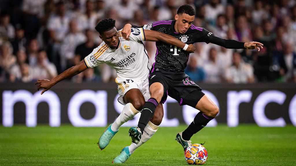 Jamal Musiala in a tussle with Real Madrid's Aurélien Tchouaméni.