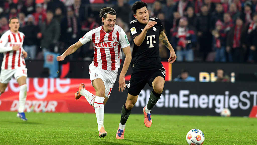 Minjae Kim im Laufduell mit Jakub Kaminski im Bundesliga-Spiel des FC Bayern beim 1. FC Köln