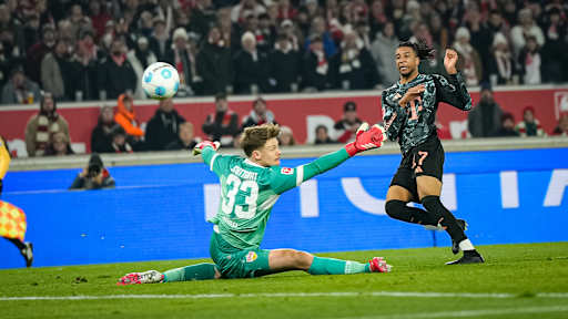 Michael Olise scores against Alexander Nübel in the Bundesliga match at VfB Stuttgart