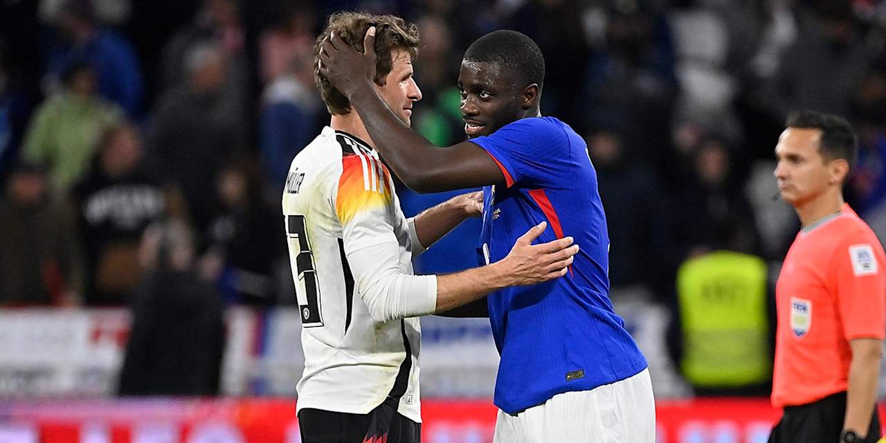 FC Bayern's Thomas Müller with Germany against Dayot Upamecano of France