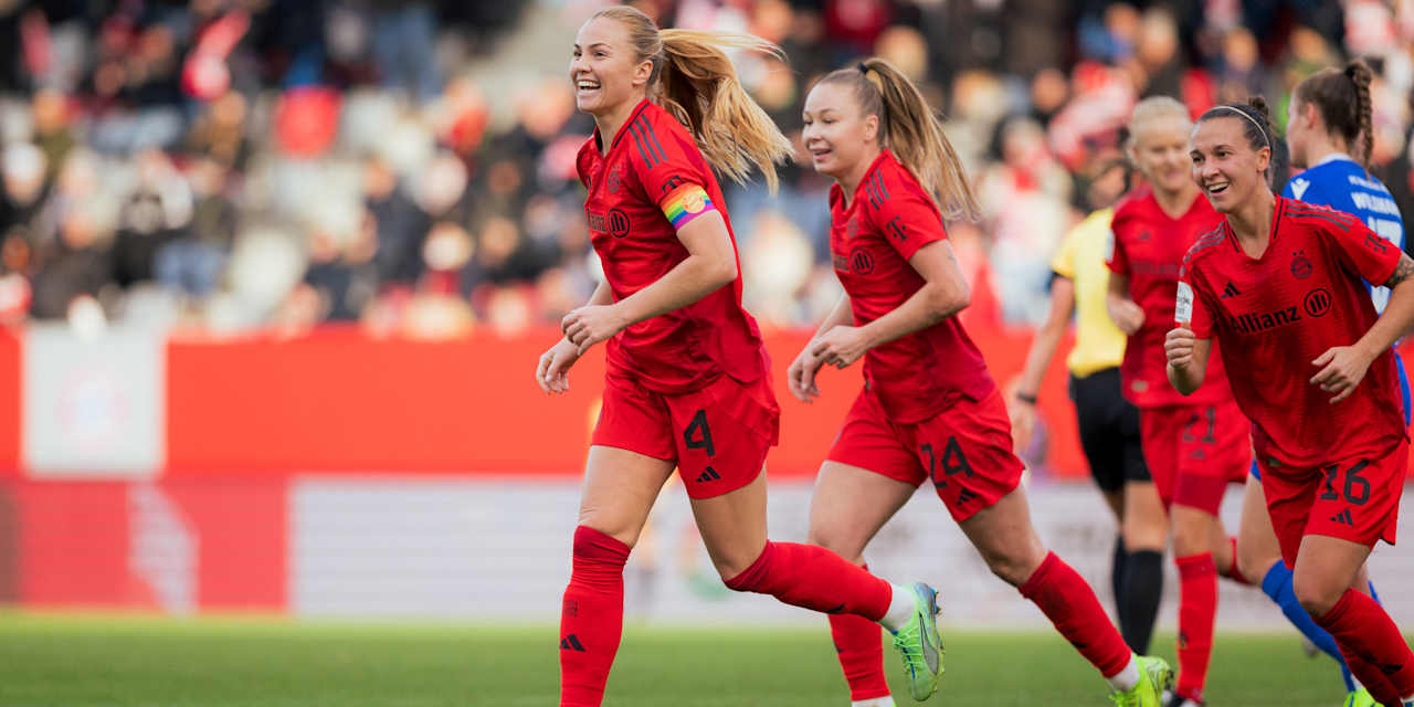 Glódís Viggósdóttir runs to her team-mates in delight after scoring a goal.
