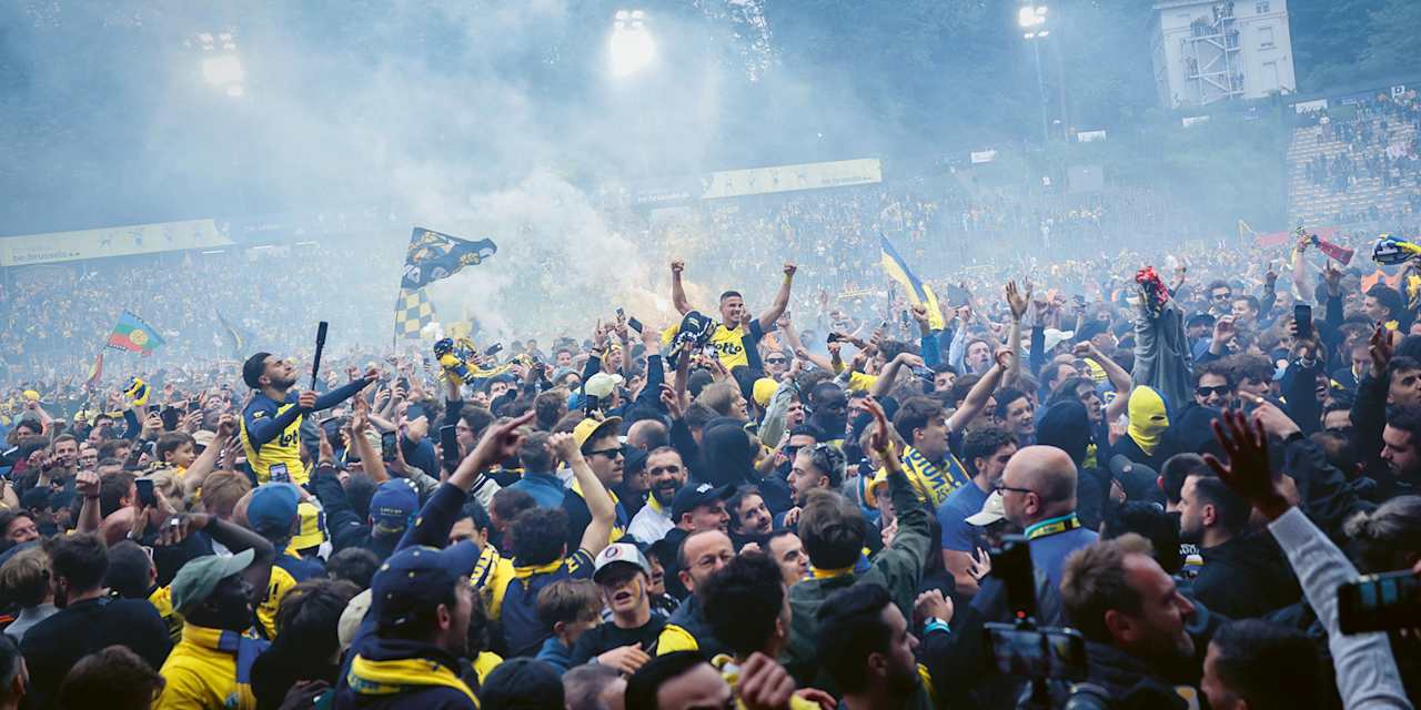 Franjo Ivanovic celebrates with fans after Union Saint-Gilloise win the title.
