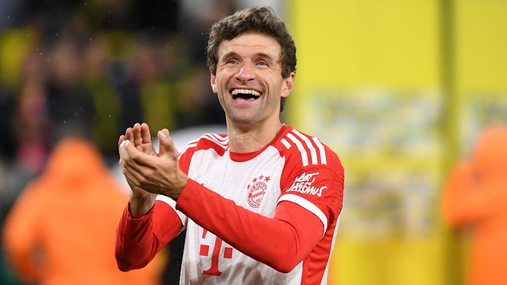 Thomas Müller celebrating after Bayern's victory over Dortmund.
