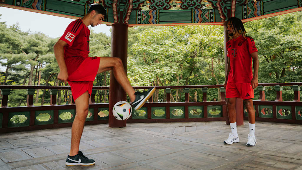 Sacha Boey and Aleksandar Pavlović model the FC Bayern home shirt.