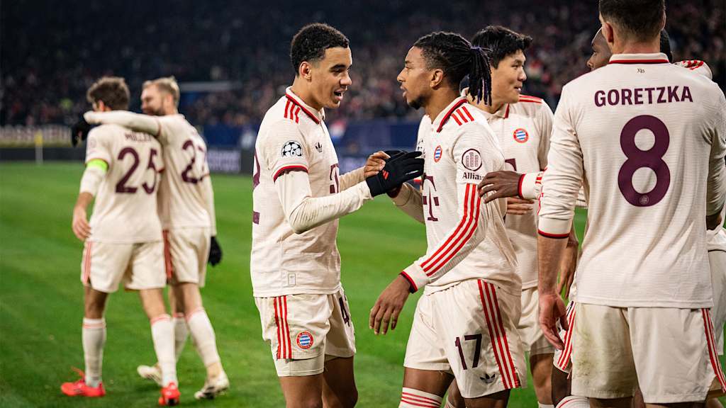 Jamal Musiala and Michael Olise celebrate after FC Bayern score against Shakhtar Donetsk.
