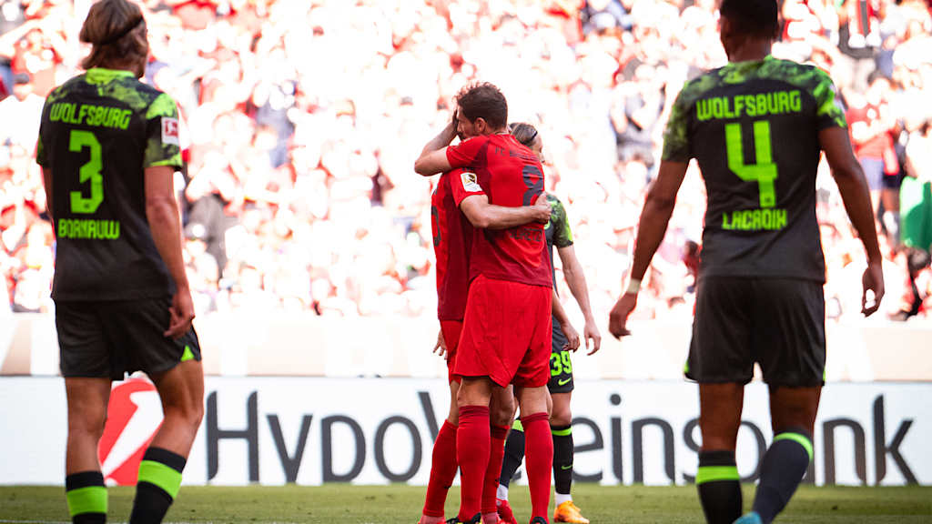 Leon Goretzka hugs a team-mate after an FC Bayern goal against VfL Wolfsburg at the Allianz Arena.