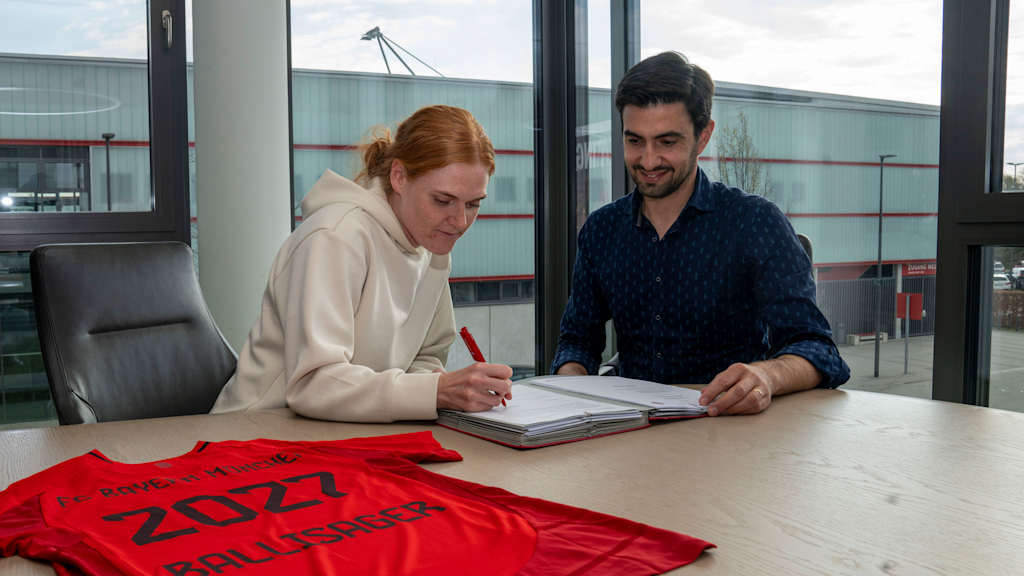 Stine Ballisager und Francisco De Sá Fardilha lächelnd während der Vertragsunterschrift am FC Bayern Campus.