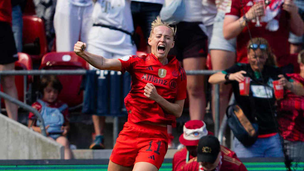 Lea Schüller jumps in the air in celebration after her goal.