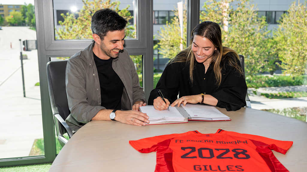 Vanessa Gilles and Francisco De Sá Fardilha sit next to each other during the contract signing.