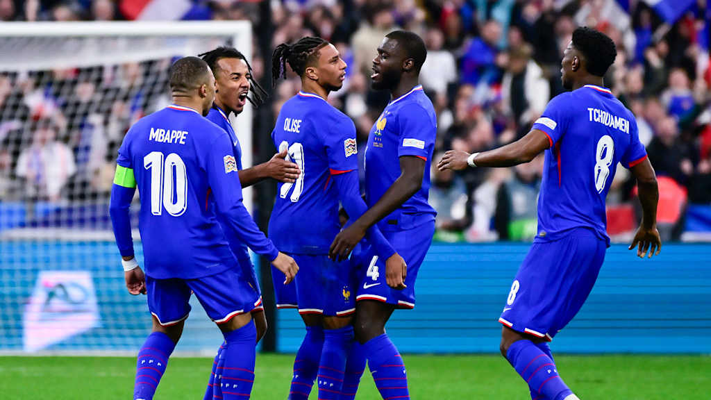 Michael Olise and Dayot Upamecano celebrate with team-mates after a goal in France's match against Croatia.