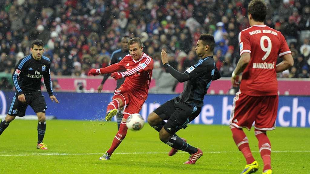 Jonathan Tah challenges Mario Götze.
