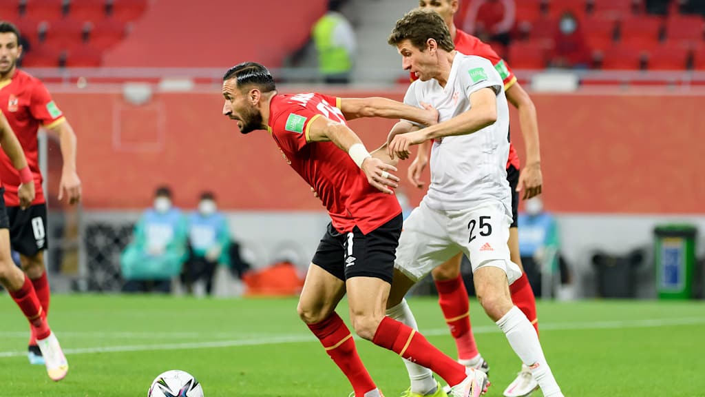 Ali Maaloul of Al Ahly SC and Thomas Mueller of Bayern Muenchen battle for the ball during the semi-final match between Al Ahly SC and FC Bayern Muenchen at Ahmad Bin Ali Stadium on February 8, 2021 in Doha