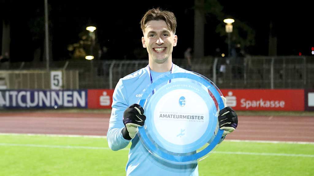 Lukas Schneller hält die Trophäe für die Meisterschaft in der Regionalliga Bayern in den Händen.