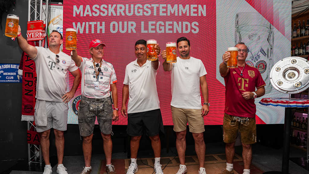 Giovane Elber and Claudio Pizarro compete with fans in beer mug lifting at the fan event at the Fritz & Franz Bierhaus in Miami