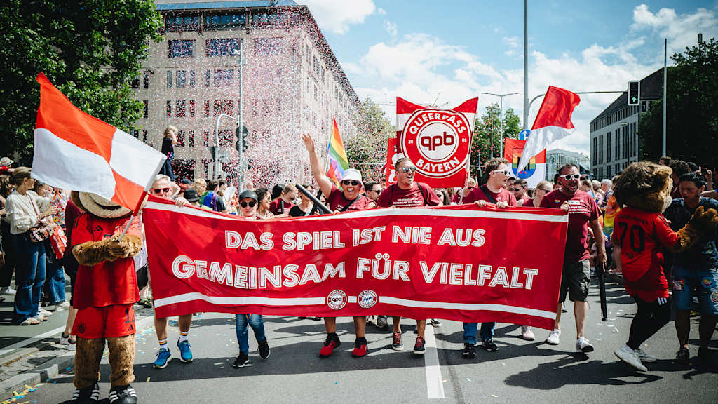 The FC Bayern fan club Queerpass Bayern taking part in the Christopher Street Day Parade with a banner.