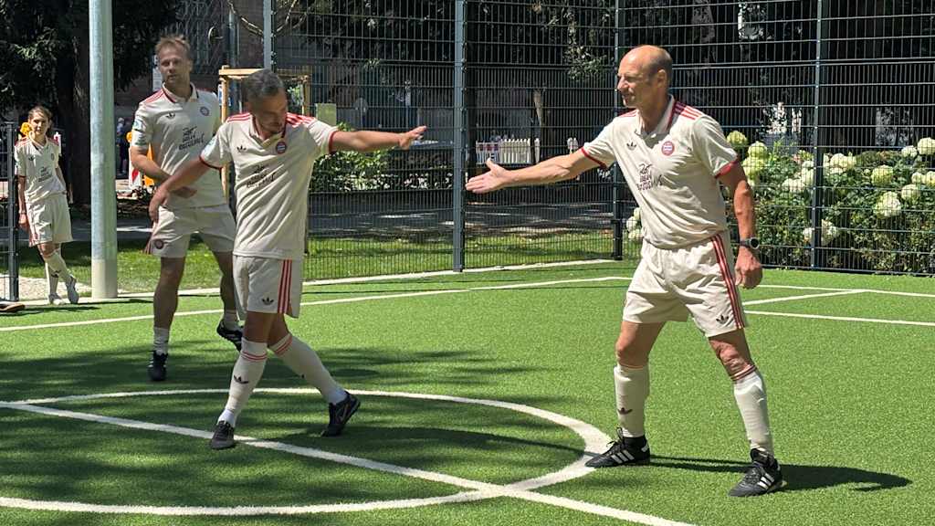 Hans Pflügler high-fives a team-mate in the small-sided tournament in the Old Botanical Garden