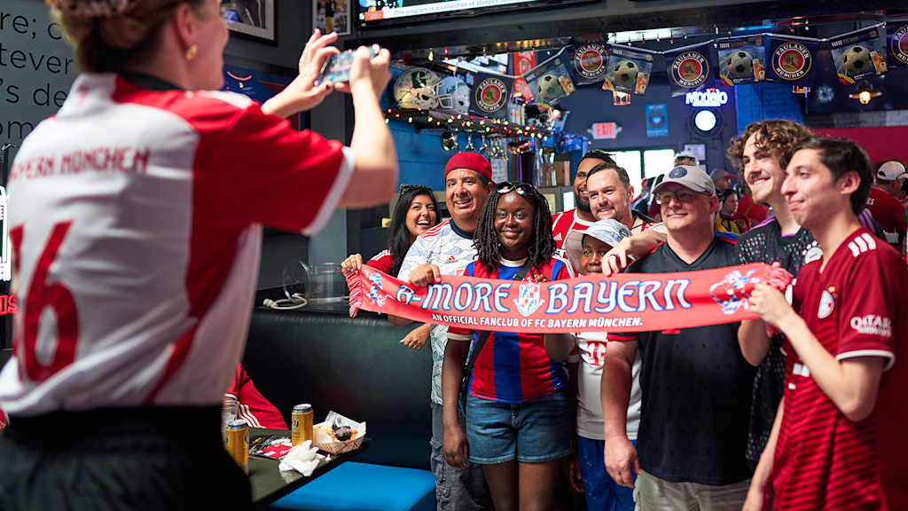 Members of an FC Bayern fan club pose for a photo at a fan event