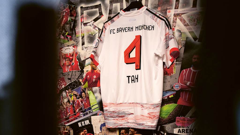 The white Bayern jersey of new signing Jonathan Tah with the number 4 hangs in front of a picture gallery.