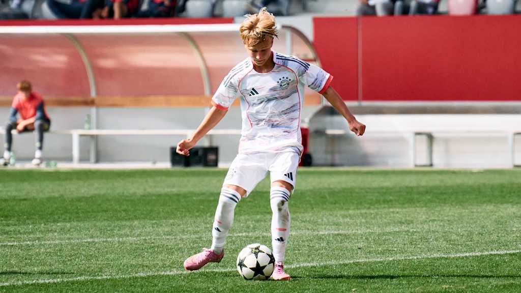 U15 Spieler im Trikot des FC Bayern mit Ball am Fuß