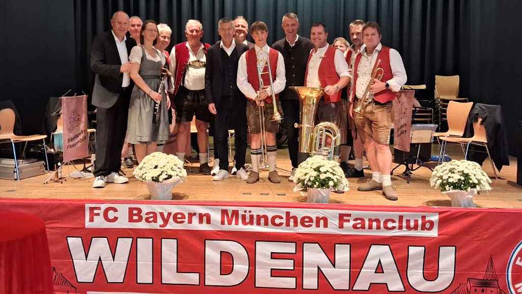 President Herbert Hainer with fans and brass band at the fan club anniversary celebration