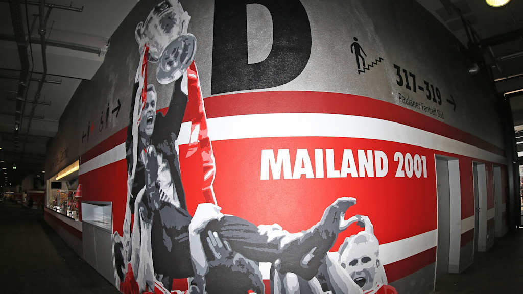 A mural in the Allianz Arena showing Ottmar Hitzfeld with the Champions League trophy, being held aloft by his Bayern side