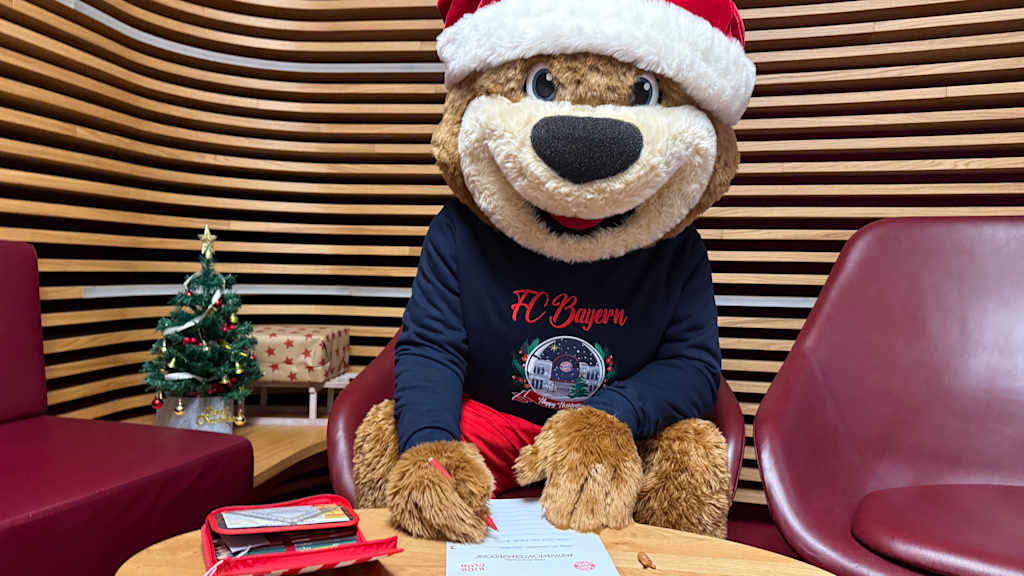 Berni schreibt seinen Wunschzettel an einem Tisch.