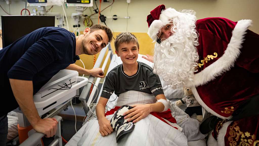 Joshua Kimmich and Serge Gnabry with two children at the children's hospital.