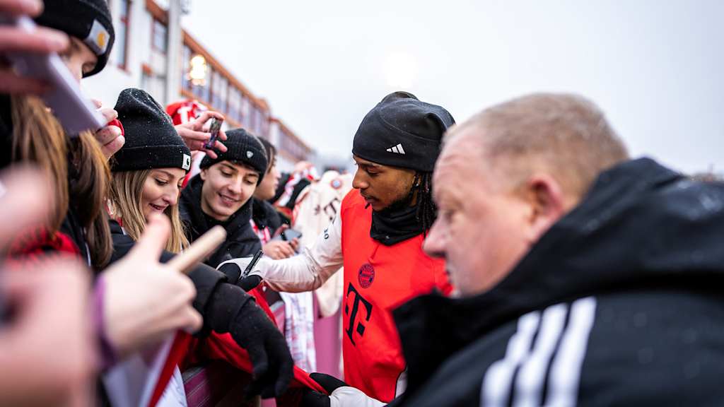 Michael Olise schreibt Autogramme im öffentlichen Training des FC Bayern vor Fans