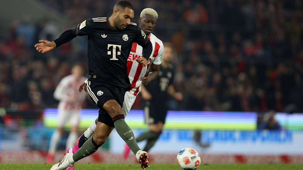 Jonathan Tah protects the ball from Ragnar Ache in FC Bayern's Bundesliga match against 1. FC Köln.