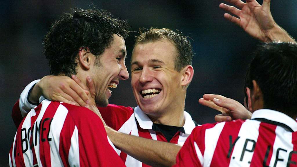 Arjen Robben smiles at Mark van Bommel - both in the red and white jersey of PSV Eindhoven.