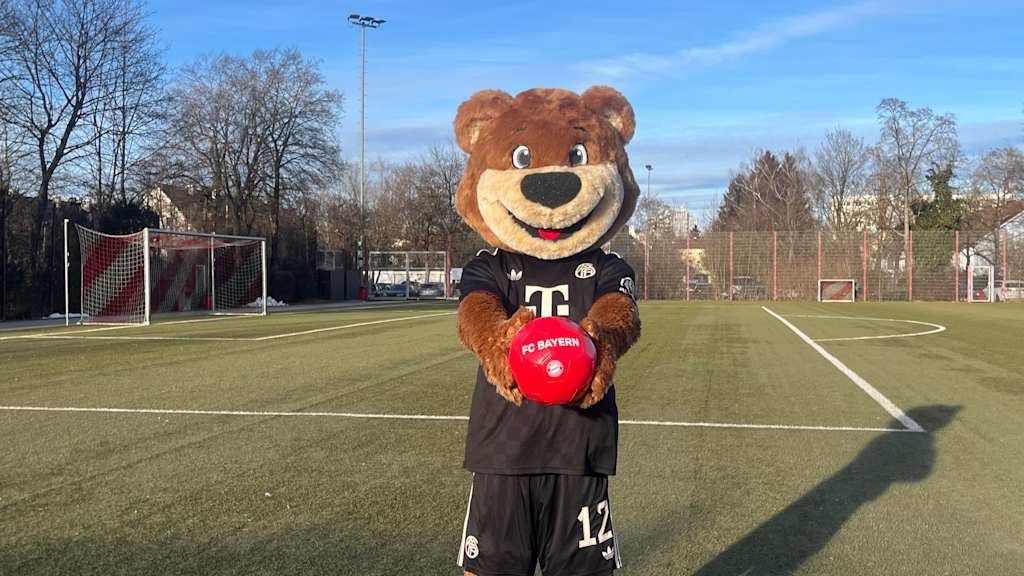 Berni auf dem Kunstrasenplatz präsentiert den Ball in seinen Händen.