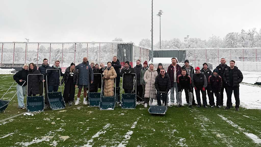 Gruppenfoto der MitarbeiterInnen des Schneeschiebens mit Vincent Kompany