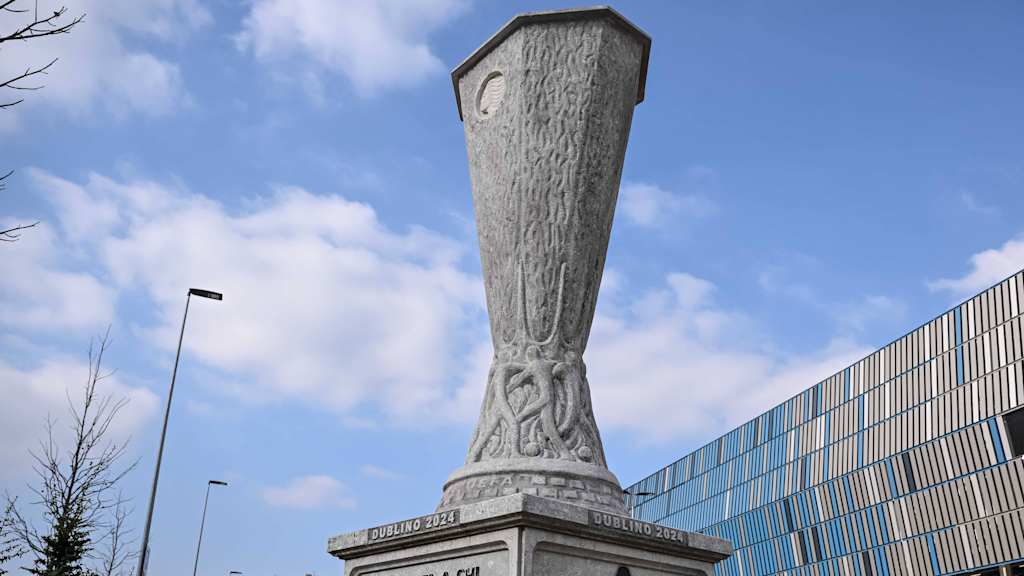 The Europa League trophy as a statue in front of the stadium.