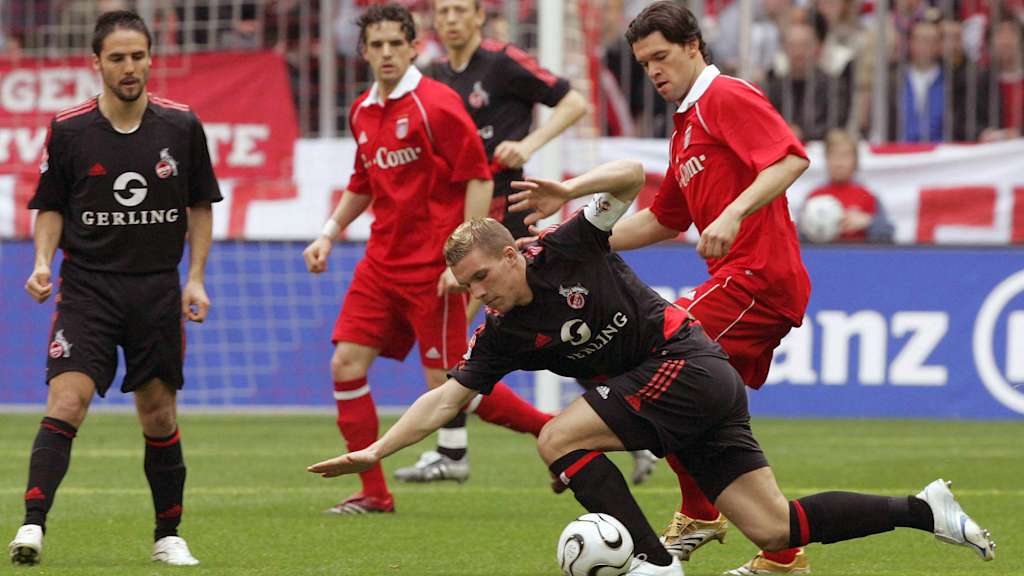 Michael Ballack, wearing a Bayern shirt, in a tussle with Kölns Podolski