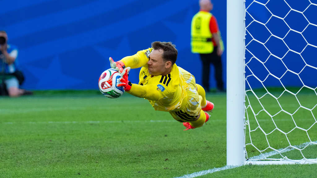 Manuel Neuer saves a powerful penalty.