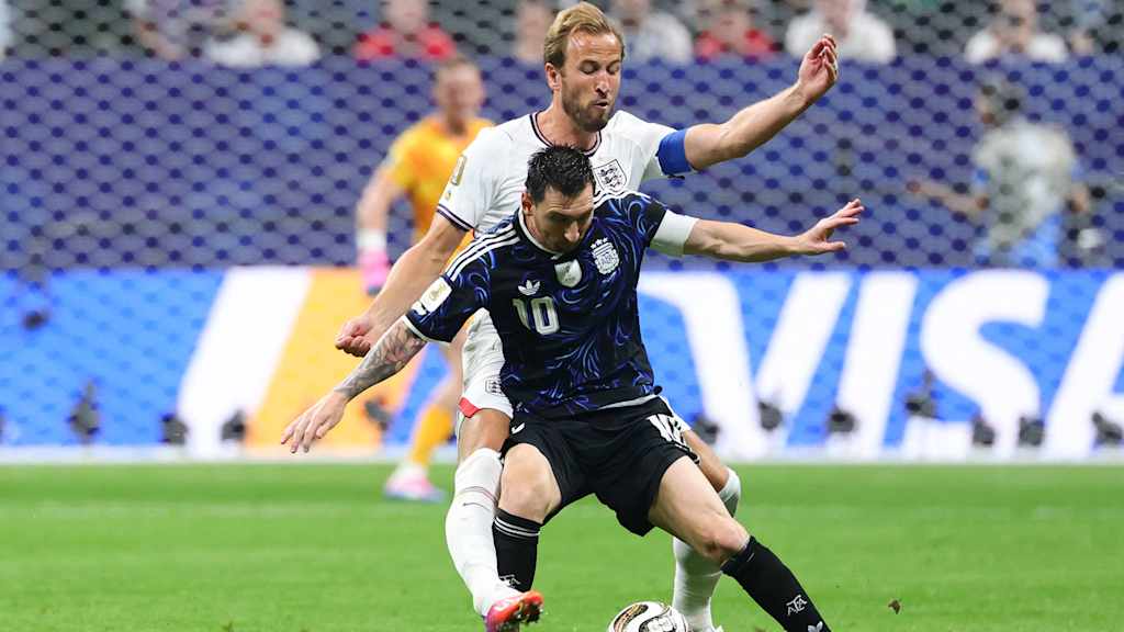 Harry Kane (England) tussles with Lionel Messi (Argentina) in the World Cup semi-final
