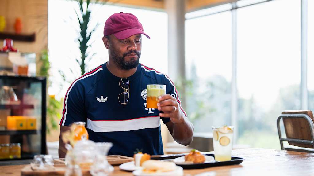 Vincent Kompany trinkt ein Glas Saft auf einer Orangenfarm
