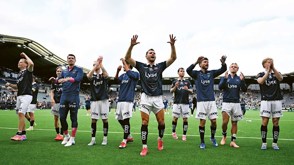 Viking players celebrating and waving to the fans