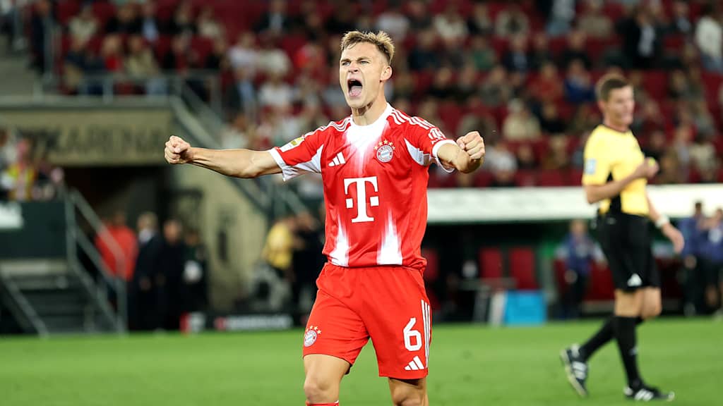 Joshua Kimmich celebrates at full time in Bayern's 3-2 win at Augsburg.