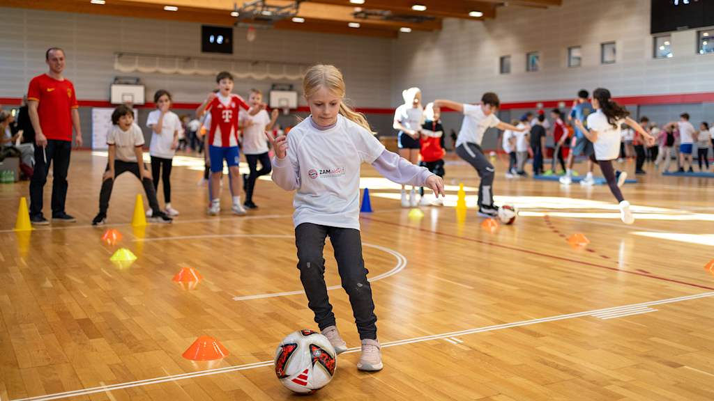 Ein Mädchen dribbelt mit einem Ball