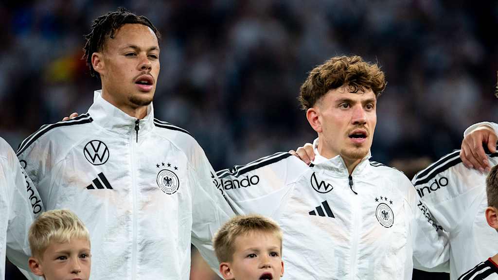 Derry Scherhant and Philipp Treu sing the national anthem before a Germany international