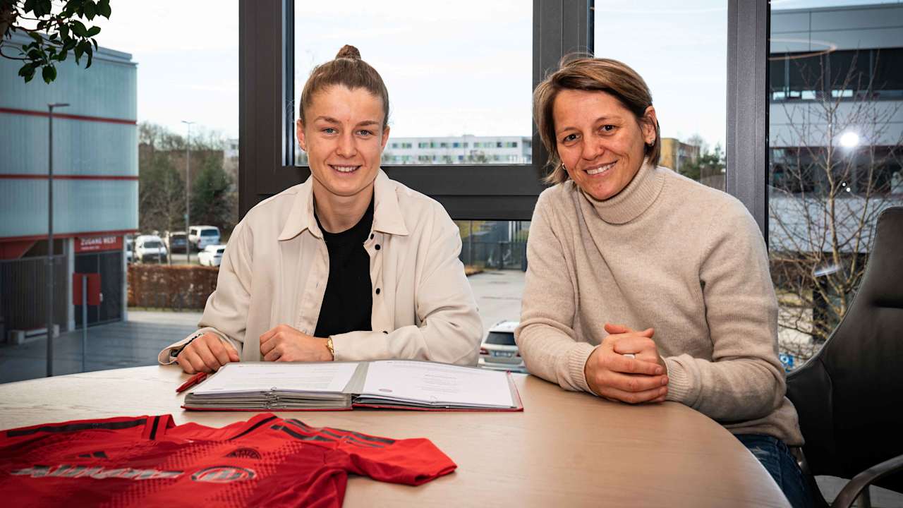 Bianca Rech and Michelle Ulbrich smile for the camera during the contract signing.