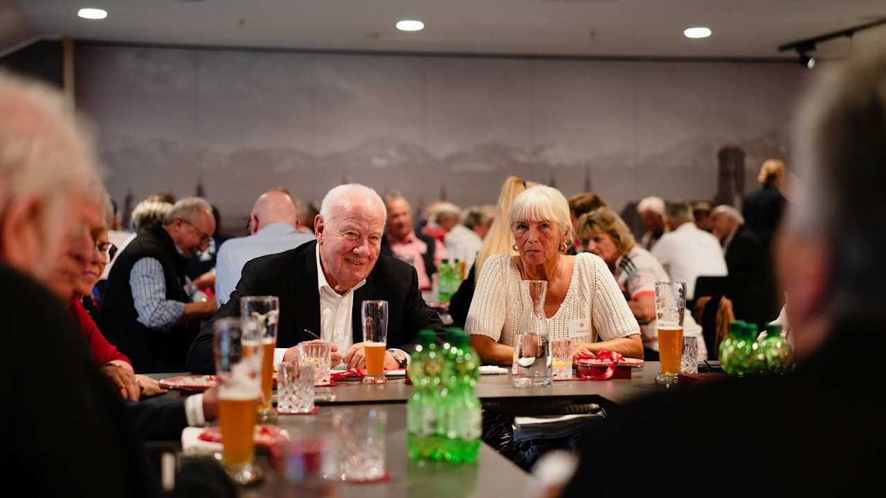 Walter Mennekes sits surrounded by FC Bayern fans at the Allianz Arena.