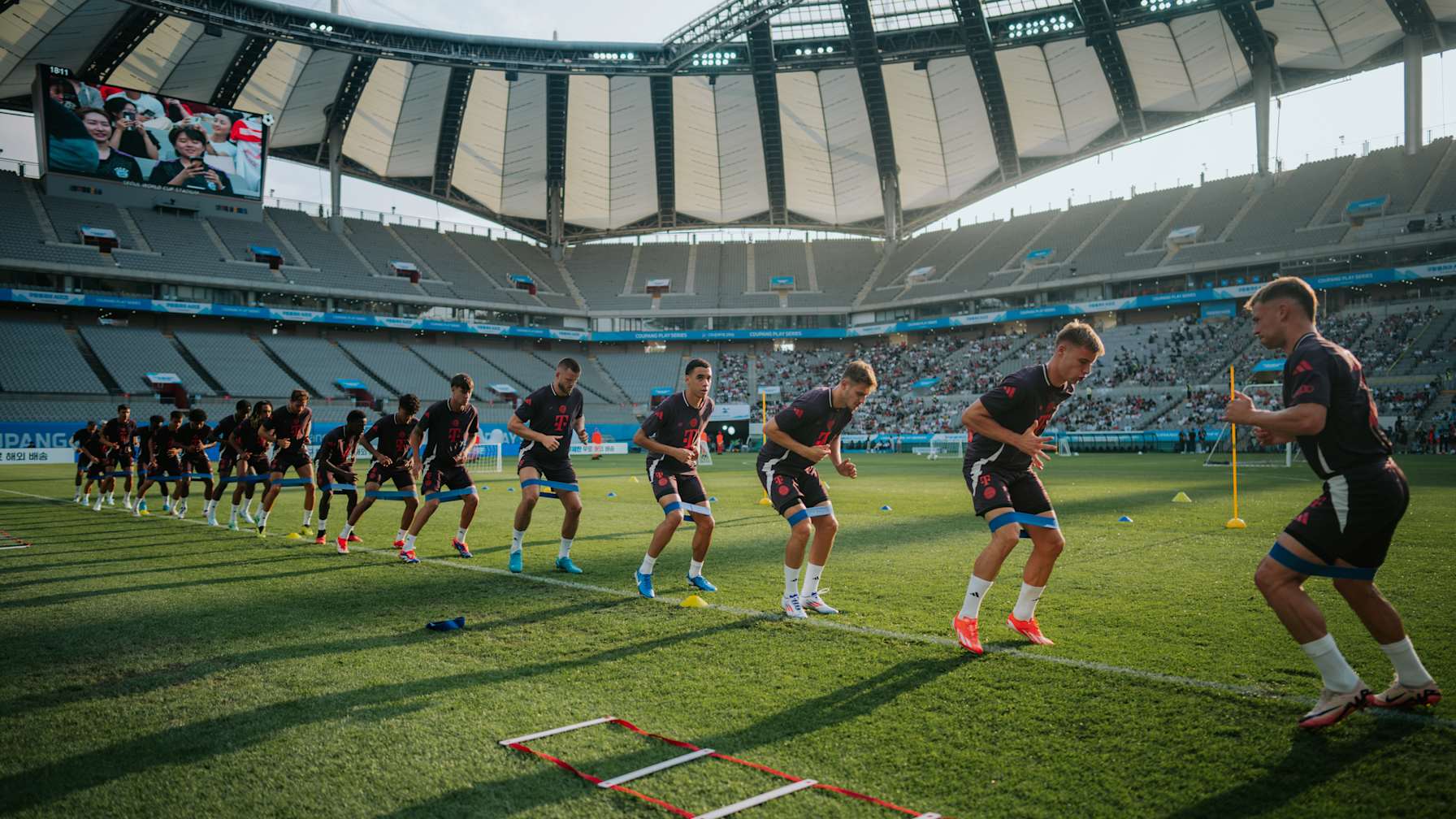 Raphael Guerreiro and Adam Aznou challenge for the ball during FC Bayern's open training in Seoul