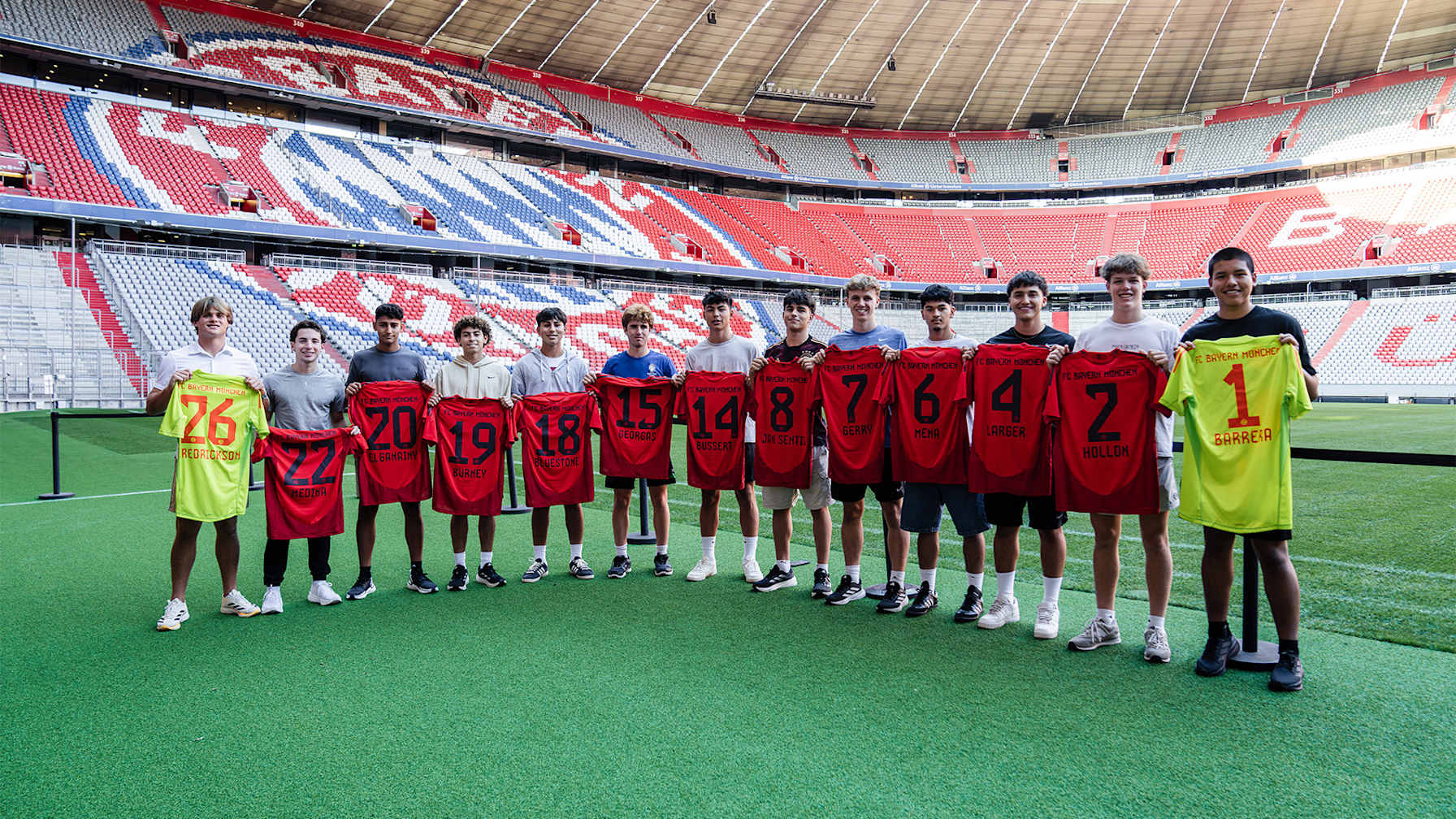 The new cohort of the FC Bayern Global Academy with their shirts in the Allianz Arena.