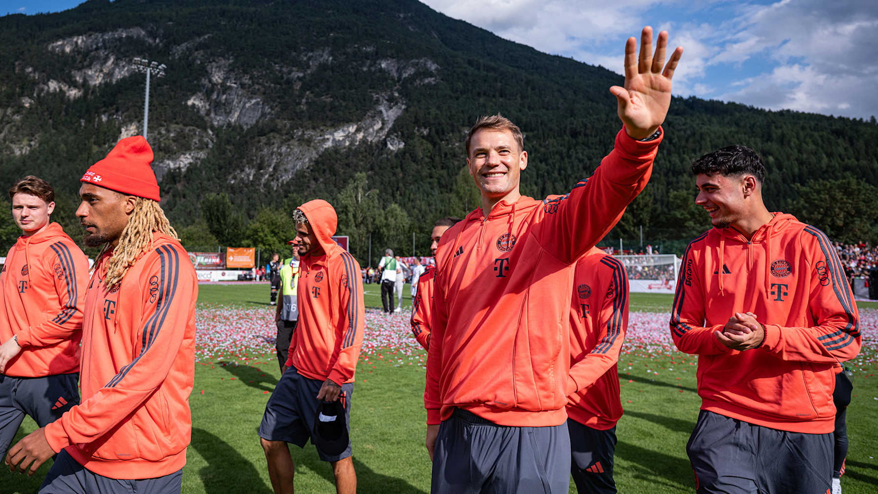 Manuel Neuer walks across the pitch smiling and applauding after FC Bayern's Dream Match against Red Eagles Austria.