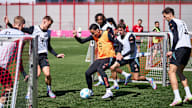 Jamal Musiala shields the ball against several opponents during FC Bayern's training session ahead of their visit to FC Augsburg